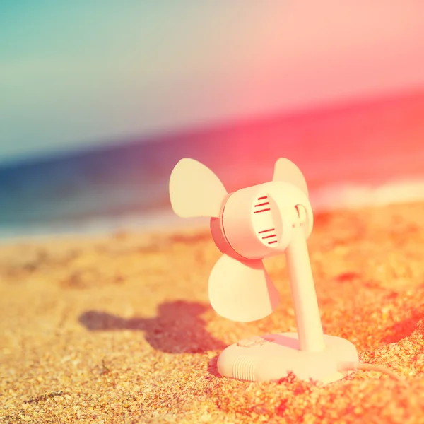 Electric fan blowing on the beach — Stock Photo, Image