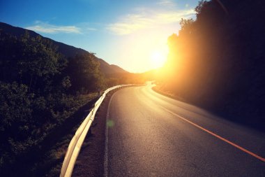 Gün batımında yol virajlı Dağı'nda bir araba. Doğa Norveç.