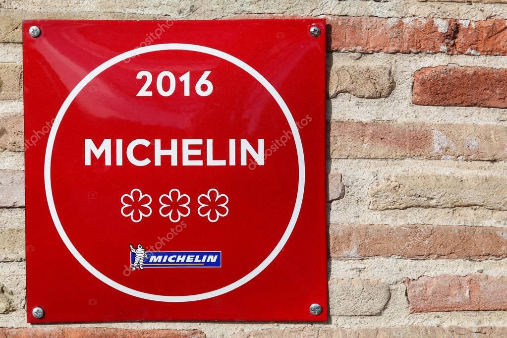 Vonnas, France - February 23, 2017: Michelin restaurant 3 stars symbol on a wall. Michelin guides are a series of guide books published by the French company Michelin for more than a century