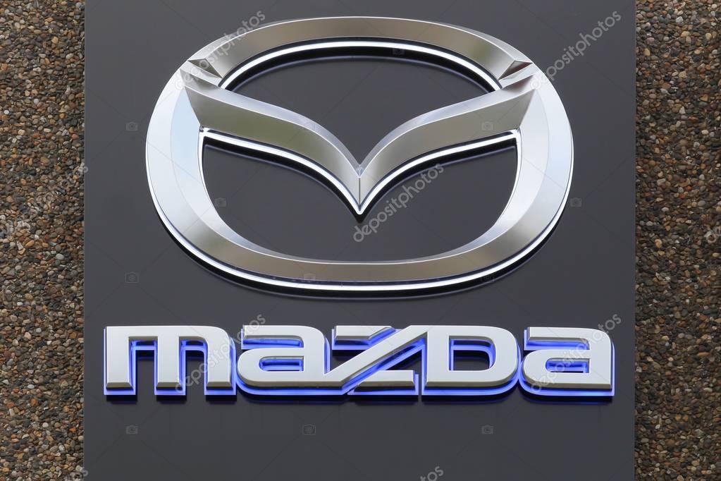 Skanderborg, Denmark - October 21, 2017: Mazda logo on a facade. Mazda is a Japanese automaker based in Fuchu, Japan