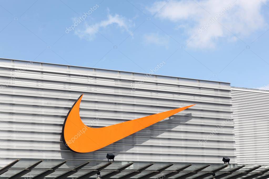 Bremen, Germany - July 2, 2017: Nike logo on a facade of a store. Nike is an American company specializing in sports equipment based in Beaverton, Oregon, USA