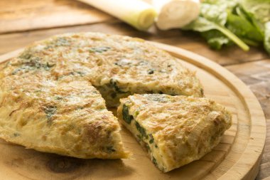 Omelette  of spinach and cheese anf leek clipart