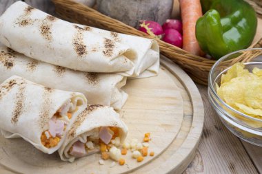 Kahvaltıda yumurtalı burrito, çedar peyniri, mikroyeşillik ve kızarmış mu