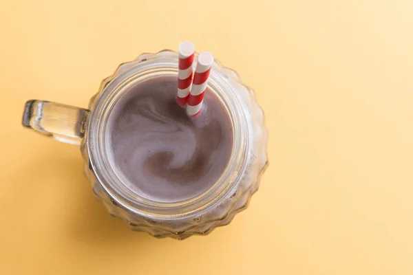 Chocolate milkshake in color background — Stock Photo, Image