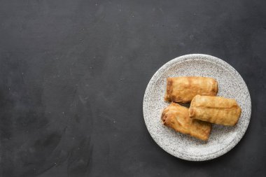 Kızarmış sebzeli börek ve taze malzemeler.