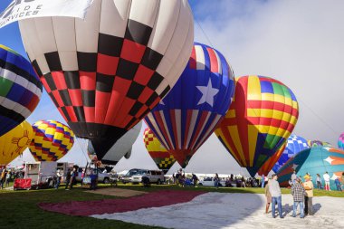 Albuquerque, New Mexico USA - October 5, 2019: Balloonists preparing their colorful hot air balloons for flight at the famous annual Albuquerque Hot Air Balloon Fiesta located in the dedicated Balloon Fiesta Park.