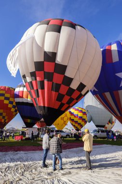 Albuquerque, New Mexico USA - October 5, 2019: Balloonists preparing their colorful hot air balloons for flight at the famous annual Albuquerque Hot Air Balloon Fiesta located in the dedicated Balloon Fiesta Park.