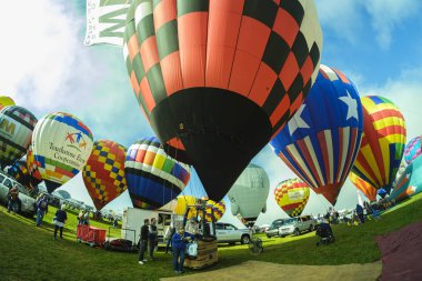 Albuquerque, New Mexico USA - October 5, 2019: Balloonists preparing their colorful hot air balloons for flight at the famous annual Albuquerque Hot Air Balloon Fiesta located in the dedicated Balloon Fiesta Park.