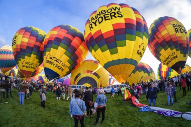 Albuquerque, New Mexico USA - October 5, 2019: Visitors gathered around the colorful hot air balloons preparing for flight at the famous annual Albuquerque Hot Air Balloon Fiesta located in the dedicated Balloon Fiesta Park.
