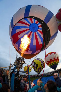 Albuquerque, New Mexico USA - October 5, 2019: Balloonist starts the burner in preparation for flight at the famous annual Albuquerque Hot Air Balloon Fiesta located in the dedicated Balloon Fiesta Park.
