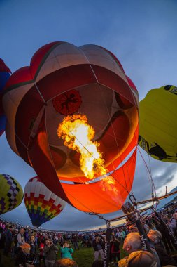 Albuquerque, New Mexico USA - October 5, 2019: Balloonist starts the burner in preparation for flight at the famous annual Albuquerque Hot Air Balloon Fiesta located in the dedicated Balloon Fiesta Park.