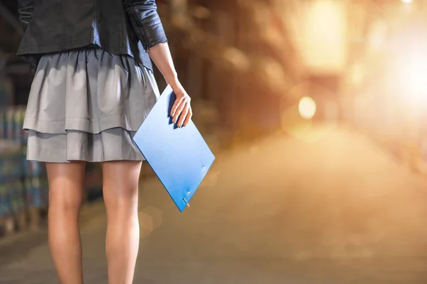 Business woman with clipboard standing in warehouse Closeup phot