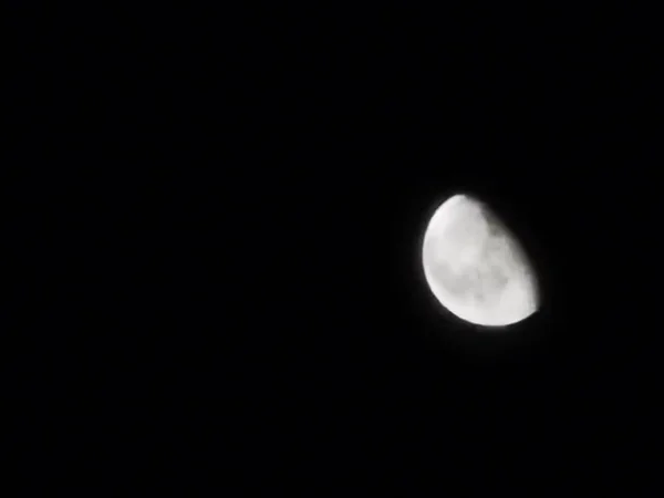 view of the half moon from the earth at night on November 18