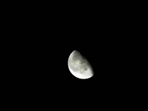 view of the half moon from the earth at night on November 18