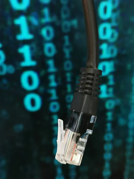 High-speed fiber optic Internet cable on the background of program code.