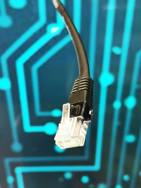 High-speed fiber optic Internet cable on the background of computer threads.