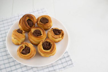 Beyaz arka planda fındık ezmeli kabuklar doluyor.