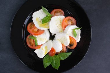 Büyük siyah tabakta salata..