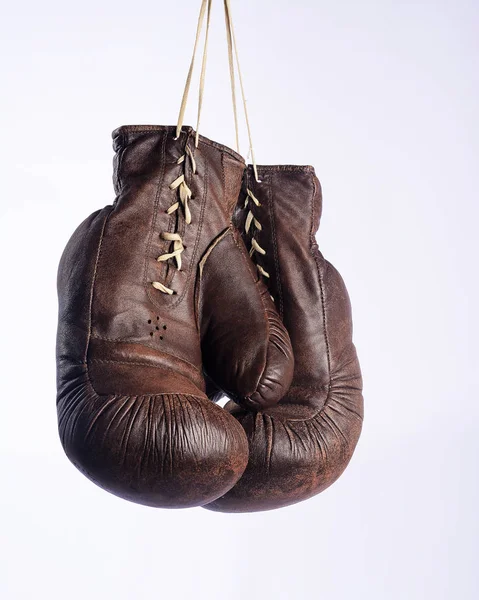 Old boxing gloves hang on nail — Stock Photo © Gladkov #22173549