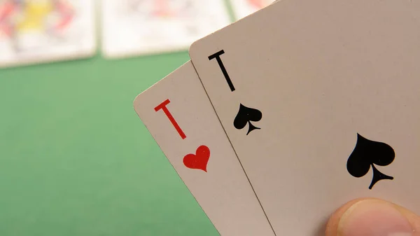 the player raises the playing cards to see