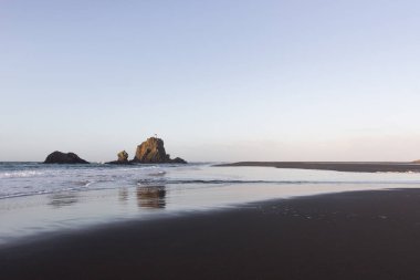 Sabahın erken saatlerinde Auckland, Yeni Zelanda 'nın batı kıyısındaki Whatipu Sahili' nin uzak deniz fenerinde..