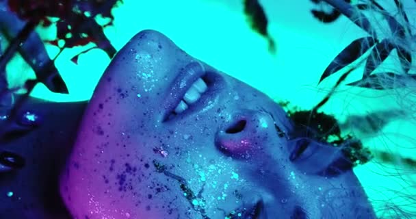 Lippen küssen sich im Neonlicht. Schönheit sexy model lippen close-up, disco. Frau Mund Nahaufnahme. Metallischer Lippenstift. Lila und blaue ultraviolette Lichter. Zeitlupe 4k Uhd video — Stockvideo