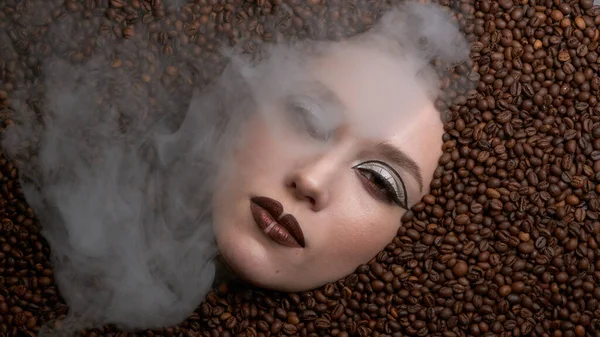 Beautiful female face in wild coffee beans