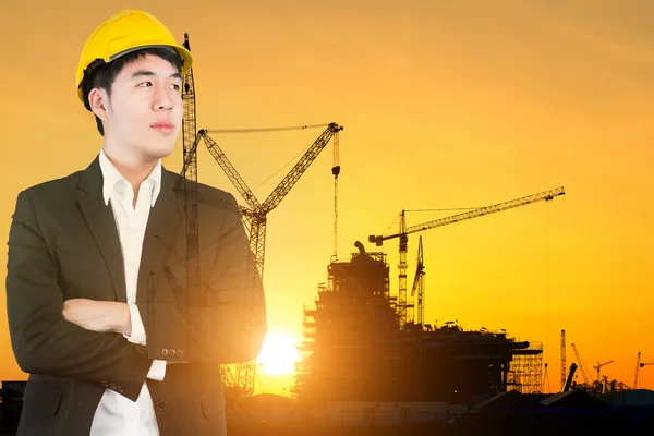 Double exposure of Engineer looking forward in construction site — Stock Photo, Image