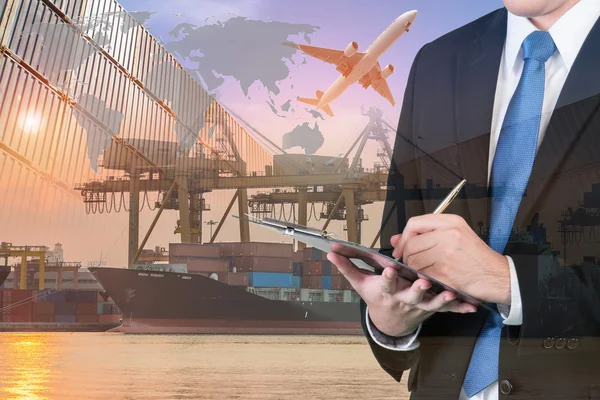 Double exposure of businessman is booking with blurred cargo , t — Stock Photo, Image