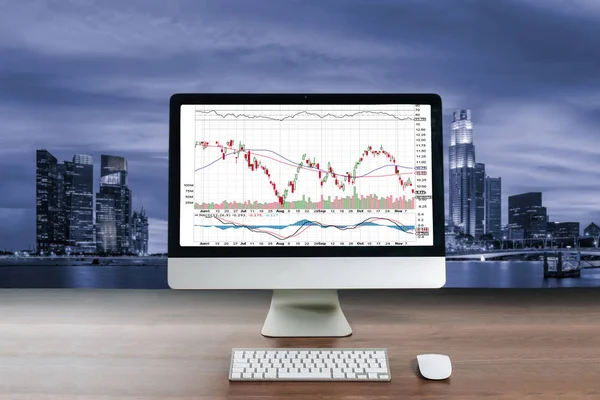 Business computer on wood table showing business trading graph w — Stock Photo, Image