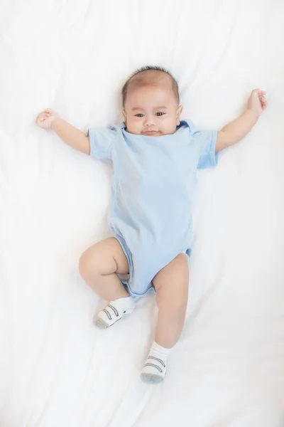 Portrait of 4 month Asian baby lying on white bed in bedroom at — Stock Photo, Image