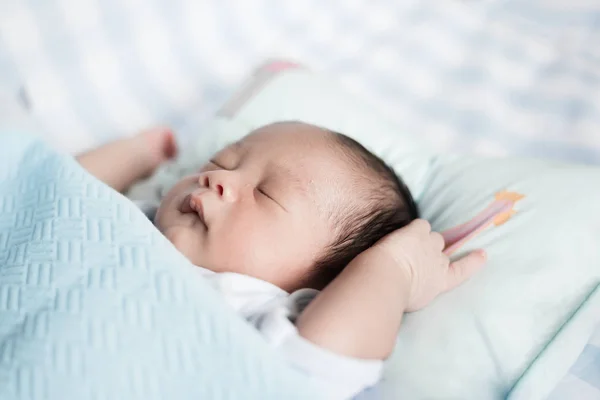 Sleeping Asian baby boy in a blue Blanket at bed. 1 month baby b — Stock Photo, Image