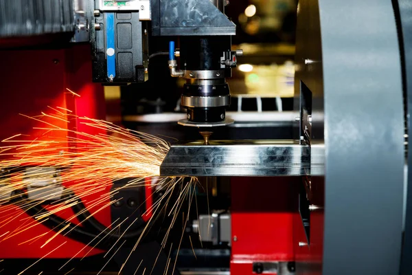 CNC laser cutting metal pipe with bright sparkle in factory. Ind — Stock Photo, Image