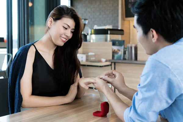 Asian handsome man putting wedding ring on and proposing to his — Stock Photo, Image