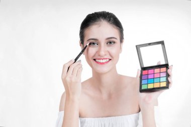 Asyalı güzel genç kadın küçük bir por göz farı uygulamak