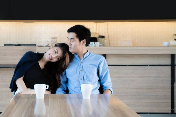 Asian beautiful young couple sitting in a cafe, drinking coffee — Stock Photo, Image