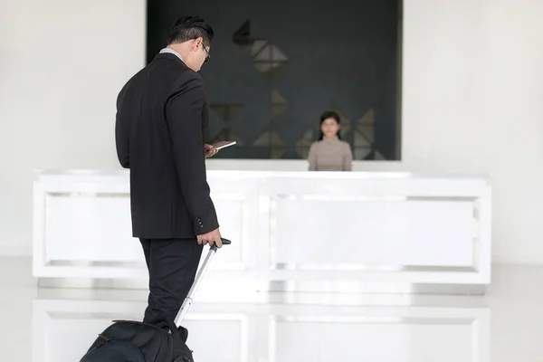 Empresário asiático caminhando para check-in na recepção do hotel front d — Fotografia de Stock