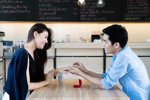 Asian handsome man putting wedding ring on and proposing to his — Stock Photo, Image