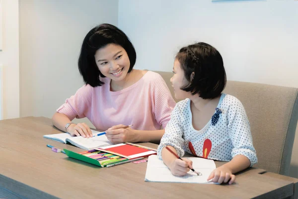 Happy Asian family. Asian Mother and daughter together drawing a