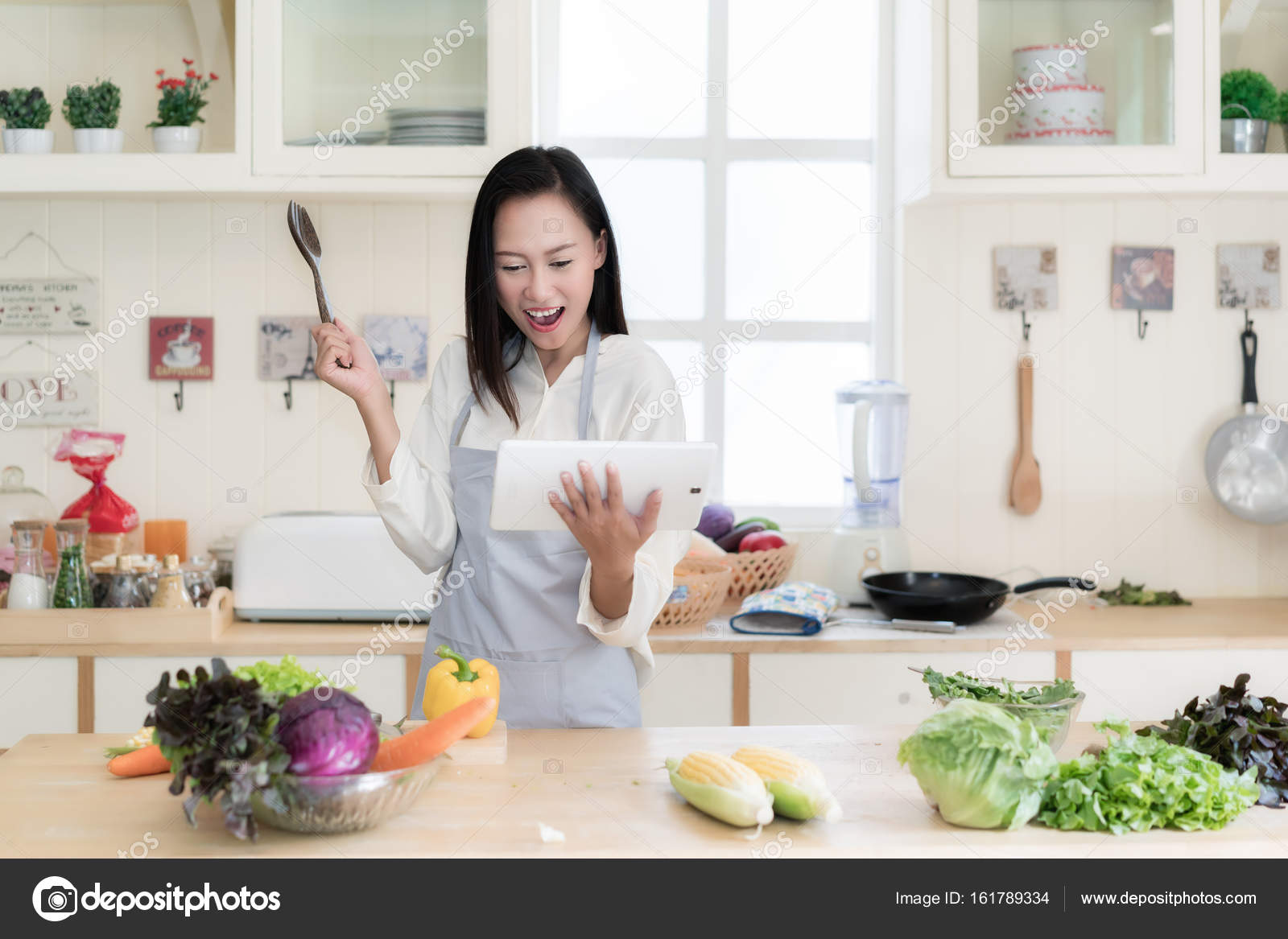 Cheerful Asian Young Woman Is Cooking In The Kitchen With Joy S Stock Photo Image By Ake1150sb 161789334
