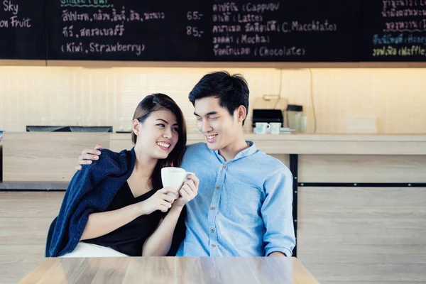 Dating in a cafe. Beautiful Asian lover couple sitting in a cafe — Stock Photo, Image