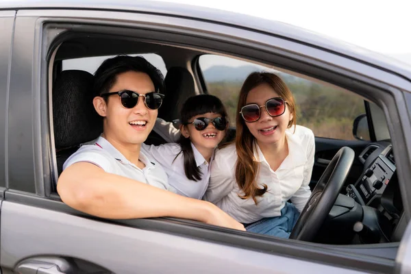 Happy Asian family with father, mother and daughter wear sunglas