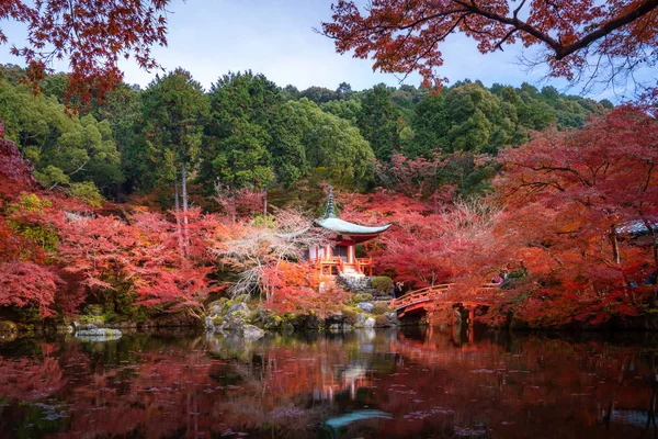 Red pagoda and red bridge with pond and color change maple trees — 스톡 사진