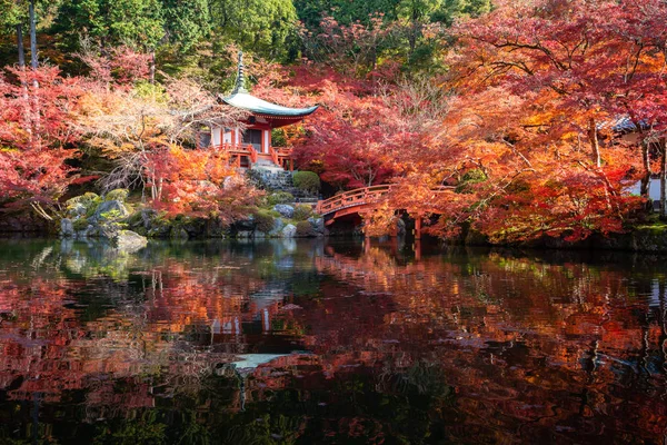 Red pagoda and red bridge with pond and color change maple trees — 스톡 사진