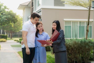 Asian woman Real estate broker agent showing a house detail in h
