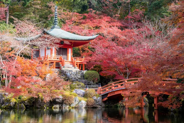 Red pagoda and red bridge with pond and color change maple trees — 스톡 사진