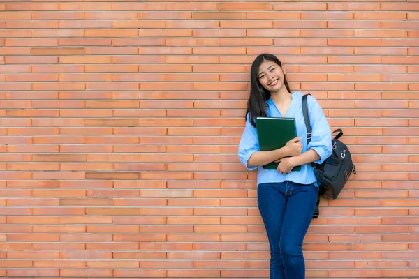 Asian Smiling Woman Student Holding Book Posing Brick Background Campus — Stock Photo, Image