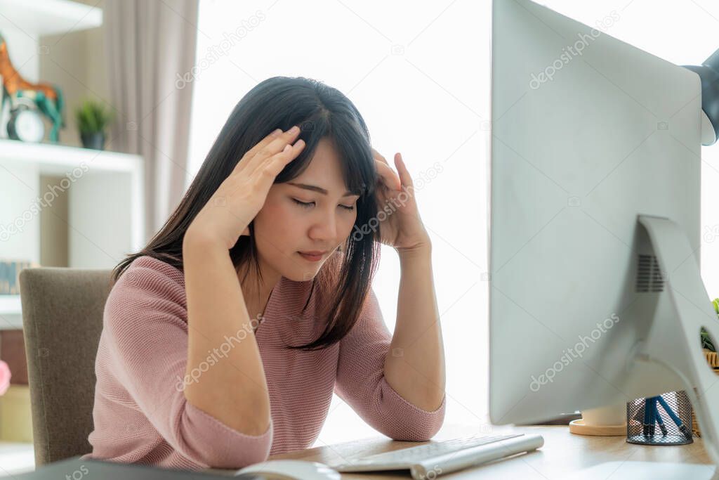 Candid of young Asian single business woman stress out with project business plan on computer laptop or notebook at home office. Asian people occupational burnout syndrome concept