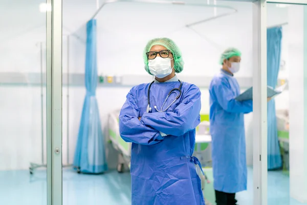 Asian doctor man and doctor team clinic personnel wearing face mask in hospital while Coronavirus outbreak