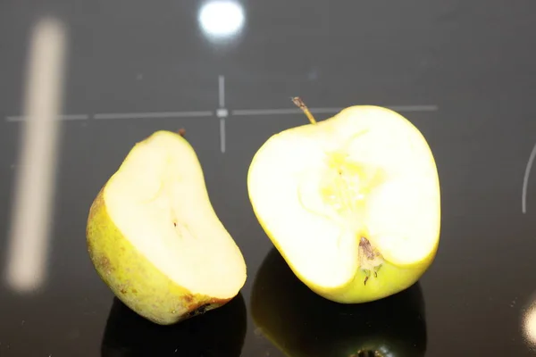 Half of apple and yellow pear